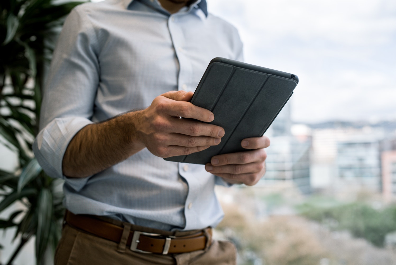 Man reading newsletter on tablet